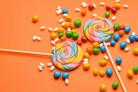 Assortment of tasty candies on color backgroundの写真素材