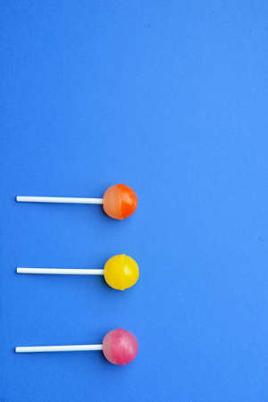 Tasty lollipops on color backgroundの写真素材