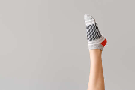 Leg of woman in sock on gray backgroundの写真素材