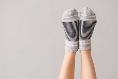 Legs of woman in socks on gray backgroundの写真素材