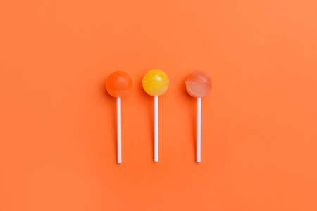 Tasty lollipops on color backgroundの写真素材