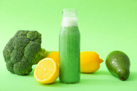 Bottle of fresh vegetable juice on color backgroundの写真素材
