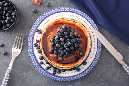 Plate with stack of tasty pancakes on tableの写真素材