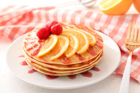 Plate with stack of tasty pancakes on tableの写真素材