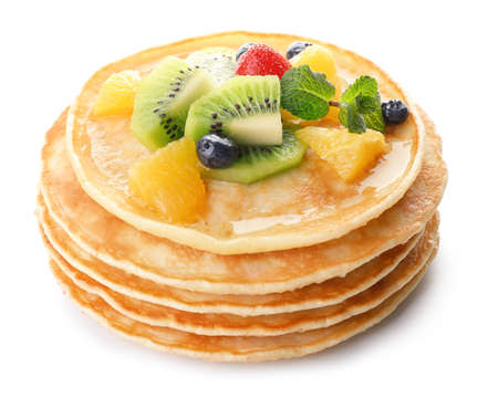 Stack of tasty pancakes with fruits on white backgroundの写真素材