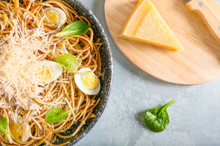 Plate with tasty pasta and cheese on color backgroundの写真素材