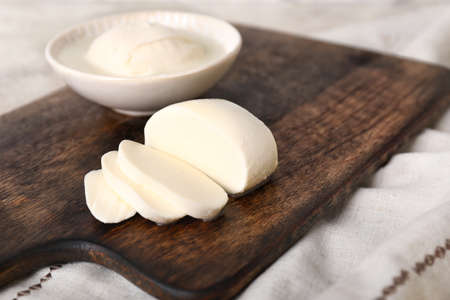 Mozzarella cheese on wooden board, closeupの写真素材