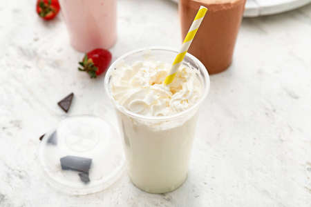 Cup of tasty milkshake on white backgroundの写真素材