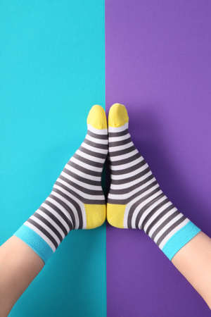 Legs of woman in socks on color backgroundの写真素材