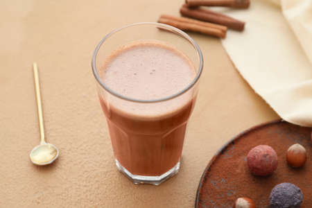 Glass of tasty milkshake on color backgroundの写真素材