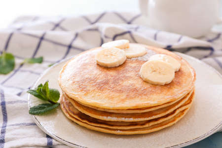 Plate with stack of tasty pancakes on tableの写真素材
