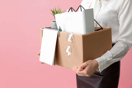 Fired woman with personal stuff on color backgroundの写真素材