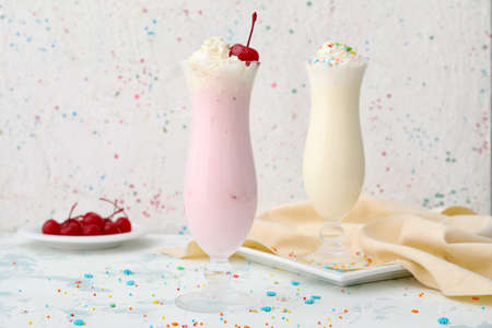 Glasses of tasty milkshakes on white backgroundの写真素材