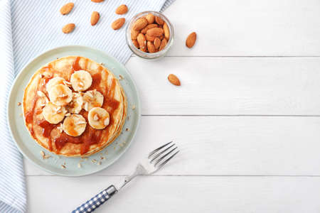 Plate with stack of tasty pancakes on tableの写真素材