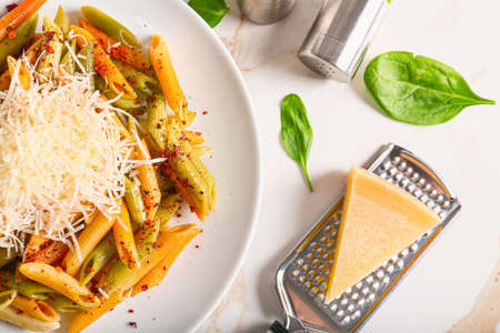 Plate with tasty pasta and cheese on white backgroundの写真素材