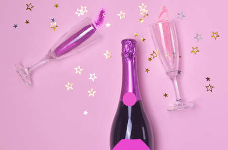 Bottle of tasty champagne and glasses on color backgroundの写真素材