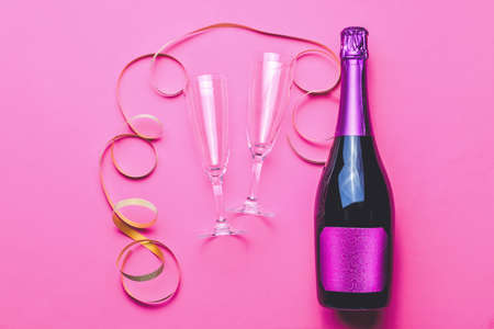 Bottle of tasty champagne and glasses on color backgroundの写真素材