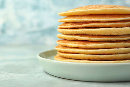 Stack of tasty pancakes on color backgroundの写真素材