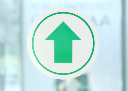 Exit sign on glass door in buildingの写真素材