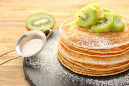 Stack of tasty sweet pancakes on slate plateの写真素材