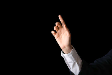 Businesswoman using virtual screen on dark background