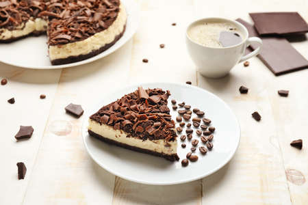 Tasty chocolate cheesecake with coffee on tableの写真素材
