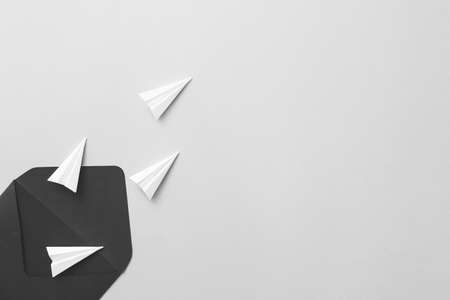 Envelope and paper airplanes on gray backgroundの写真素材