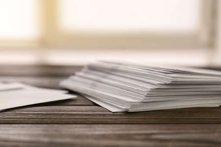 Many paper envelopes on table