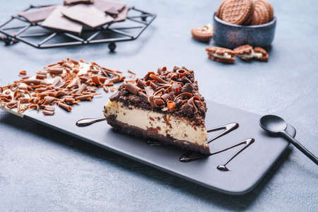 Piece of tasty chocolate cheesecake on tableの写真素材