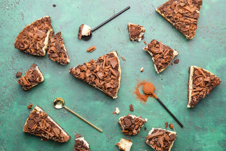 Pieces of tasty chocolate cheesecake on color backgroundの写真素材