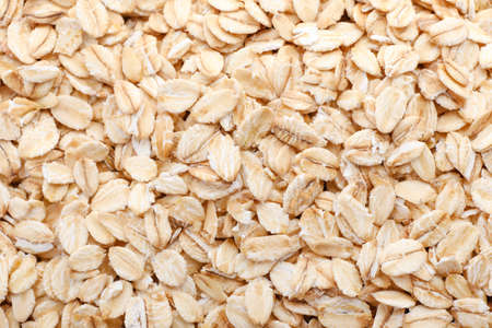 Raw oatmeal as background, closeup