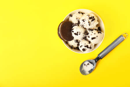 Bowl with tasty ice cream on color backgroundの写真素材