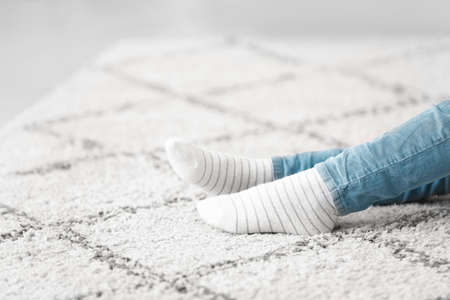 Little girl in cotton socks at homeの写真素材
