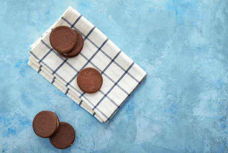 Tasty chocolate cookies on color background