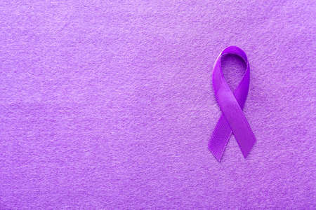 Violet ribbon on color background. Domestic violence conceptの写真素材