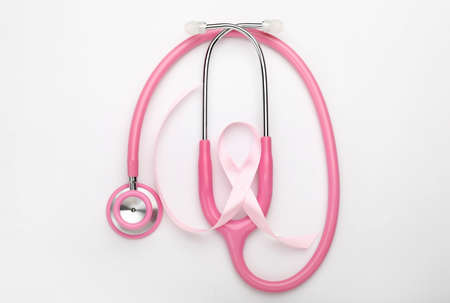 Pink ribbon with stethoscope on white background. Breast cancer awareness conceptの写真素材