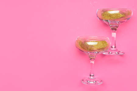 Glasses for champagne with glitter on color backgroundの写真素材