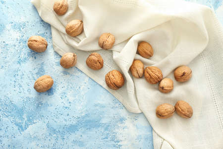 Tasty walnuts on color background
