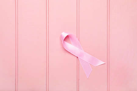 Pink ribbon on white wooden background. Breast cancer awareness conceptの写真素材