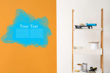 Cans of paints and tools on rack against color background with space for textの写真素材