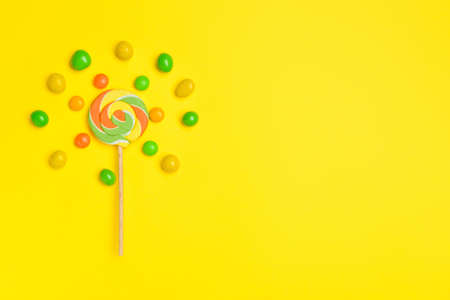 Tasty candies on color background