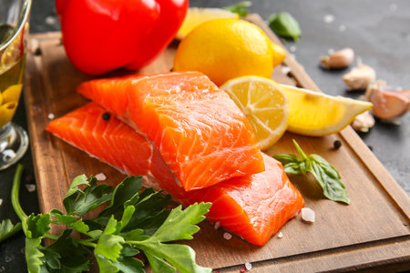 Raw salmon fillet with lemon on table