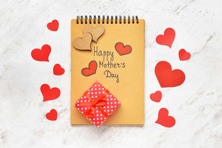 Beautiful gift for Mother's Day and notebook on white background
