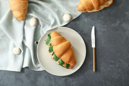 Tasty croissant sandwich on dark backgroundの写真素材