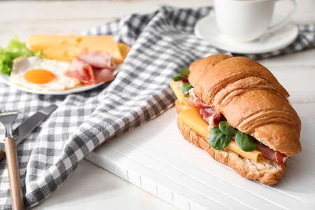 Tasty croissant sandwich on tableの写真素材