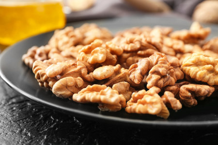 Plate with tasty walnuts on table, closeupの写真素材