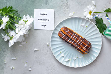 Tasty cake with flowers for mother on light backgroundの写真素材