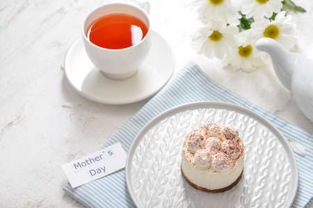 Tasty breakfast for mother on white background