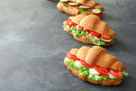Tasty croissant sandwiches on dark backgroundの写真素材
