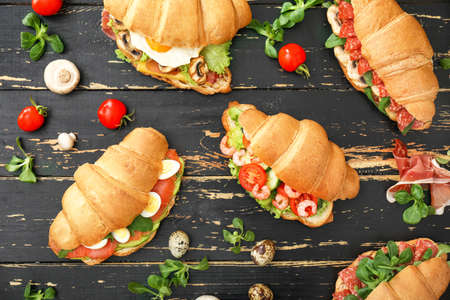 Tasty croissant sandwiches on tableの写真素材